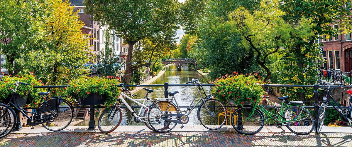 Bikes parked on a bridge running over a canal in Utrecht, Netherlands